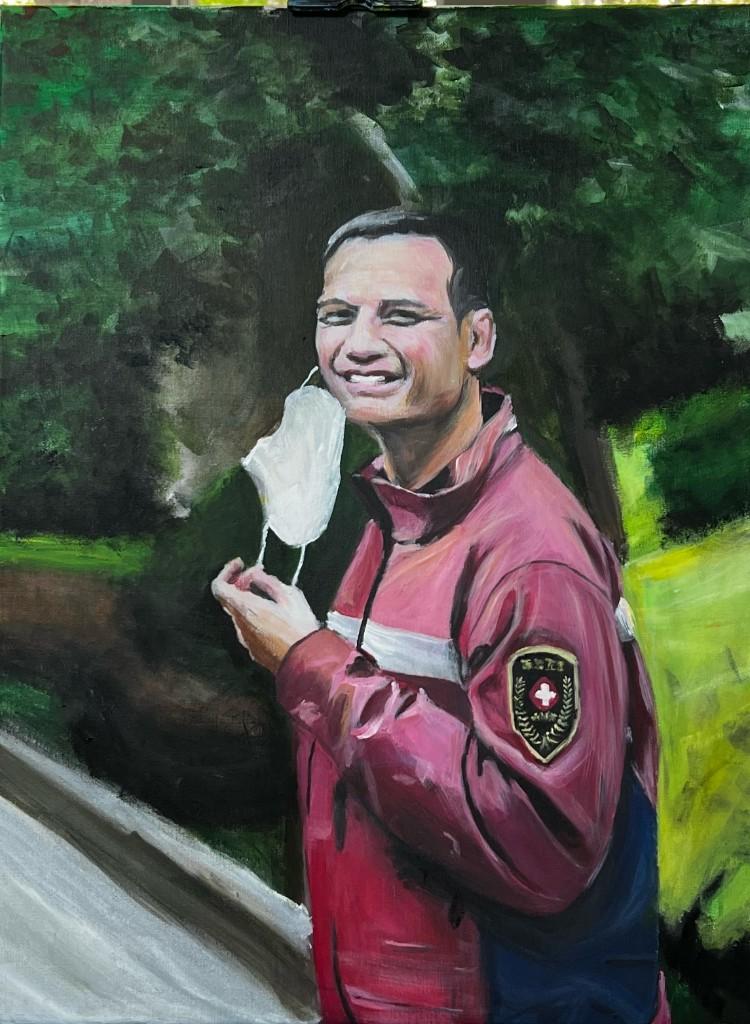 Portrait of a smiling man in a red jacket holding a white face mask, outdoor setting